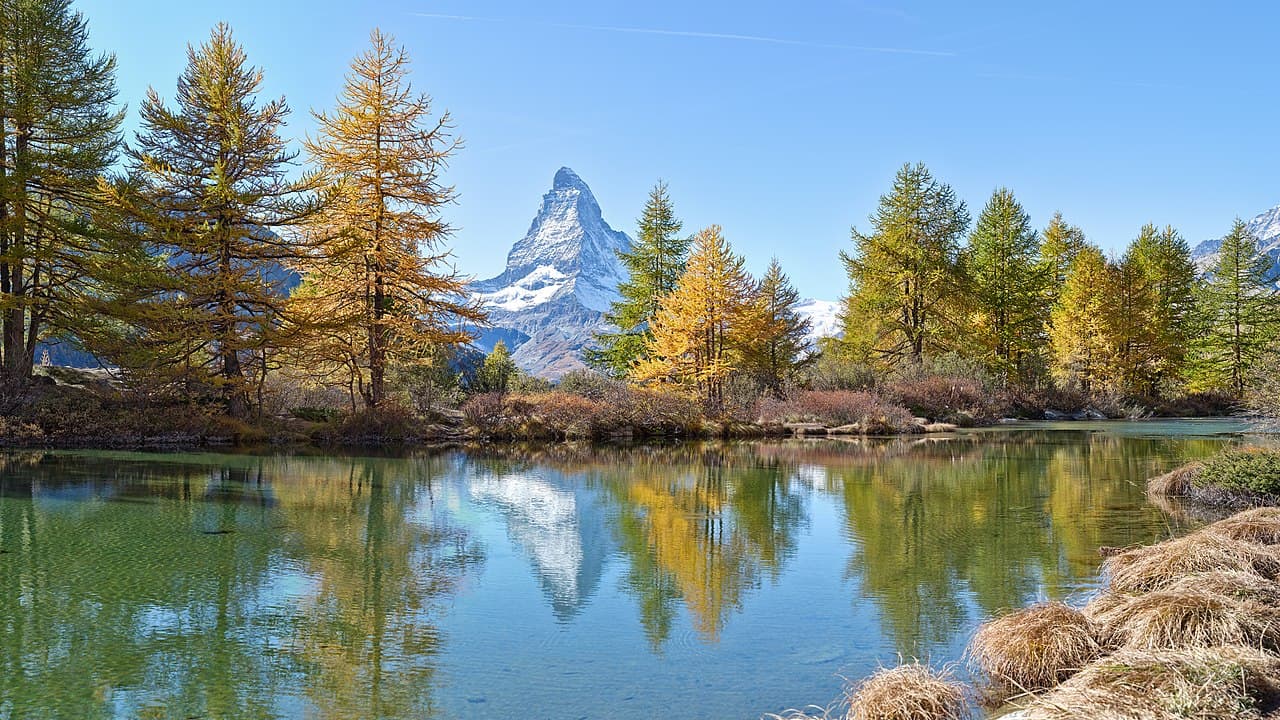 The Matterhorn reflected in a still alpine lake at sunrise