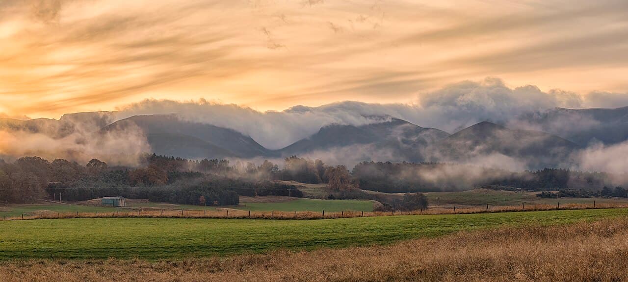 Warm sunrise light over the Cairngorm mountains in Scotland